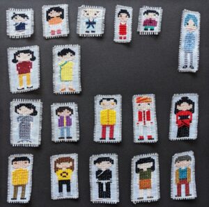 18 cross stitched people dressed in primarily traditional Chinese clothing